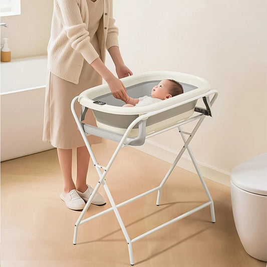  maman observe son bebe ndans la baignoire pliable. bebe